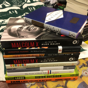 a stack of books by and about people of color